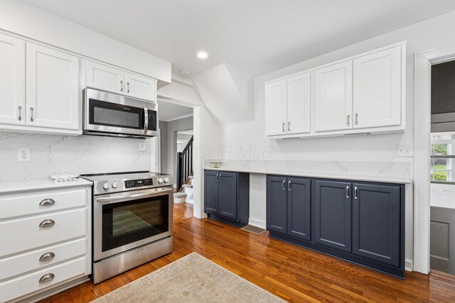 kitchen featuring dark wood-type flooring, recessed lighting, white cabinetry, backsplash, and stainless steel appliances