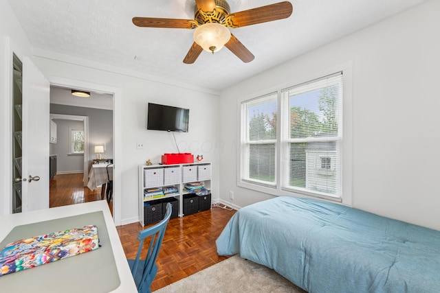 bedroom featuring baseboards and ceiling fan