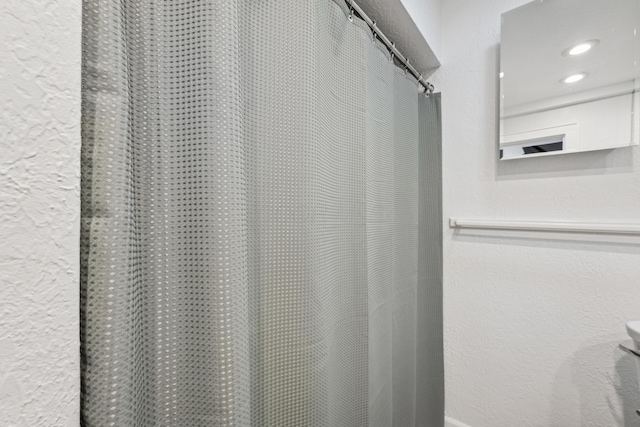 bathroom with a shower with curtain