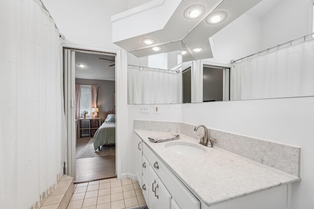 ensuite bathroom featuring vanity, connected bathroom, and tile patterned floors