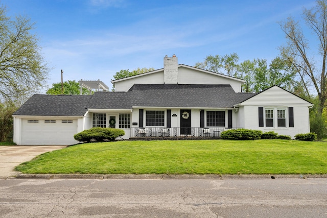 view of front of home with driveway, a chimney, roof with shingles, a front yard, and an attached garage