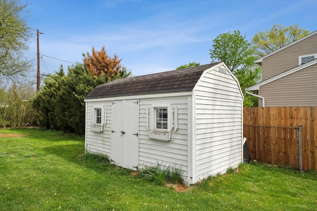 view of shed featuring fence