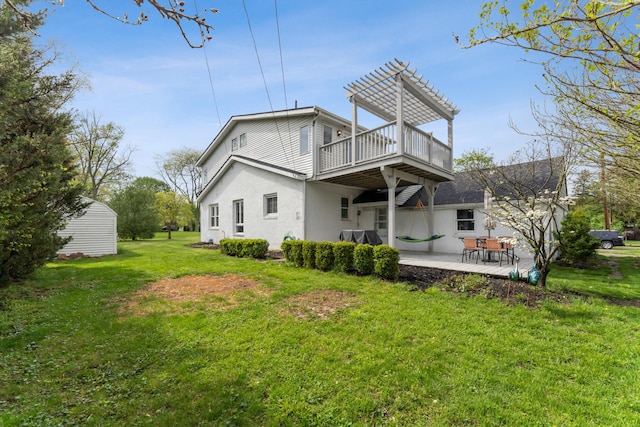 back of house with a lawn, a patio area, a balcony, a pergola, and stucco siding