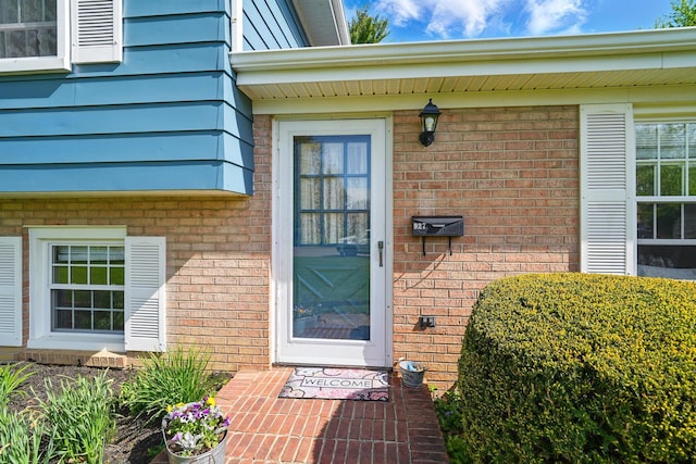 entrance to property featuring brick siding