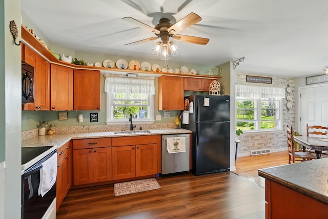 kitchen featuring black appliances, visible vents, plenty of natural light, and a sink