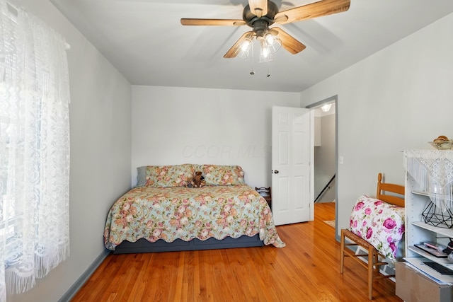 bedroom featuring a ceiling fan and wood finished floors