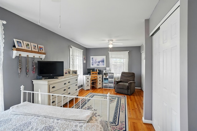 bedroom featuring ceiling fan, a closet, and light wood finished floors