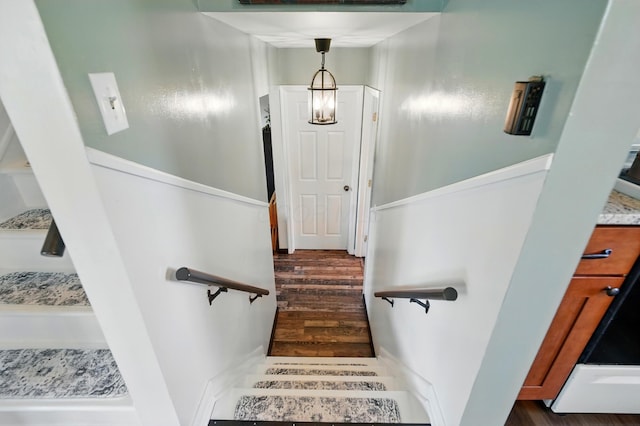 staircase with wood finished floors