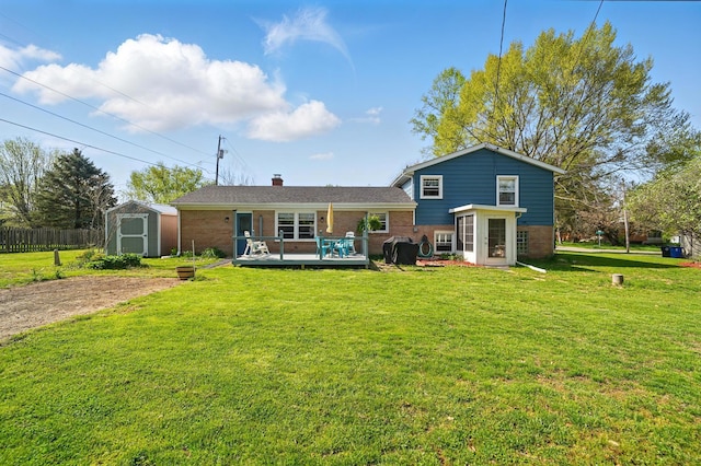 rear view of house with a storage unit, a deck, an outbuilding, a yard, and brick siding