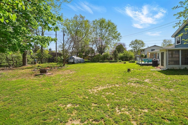 view of yard with a fire pit and a sunroom