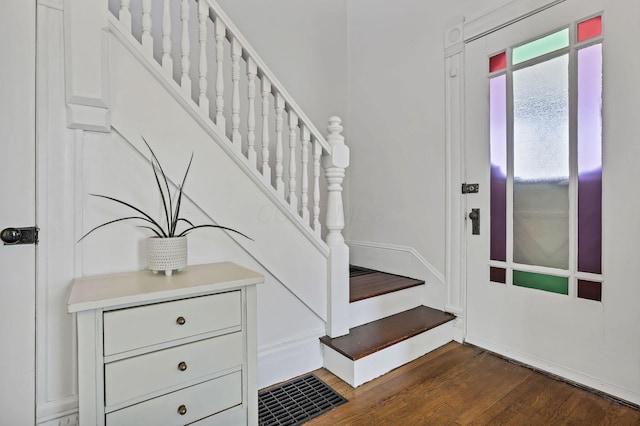 704 E High St, Mount Vernon, OH 43050 - entryway featuring baseboards, stairs, and dark wood-style floors