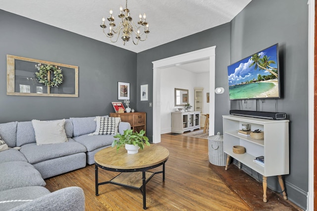 704 E High St, Mount Vernon, OH 43050 - living room with baseboards, wood finished floors, and a notable chandelier