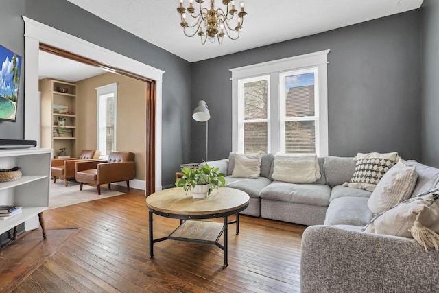 704 E High St, Mount Vernon, OH 43050 - living area featuring an inviting chandelier, hardwood / wood-style floors, and baseboards