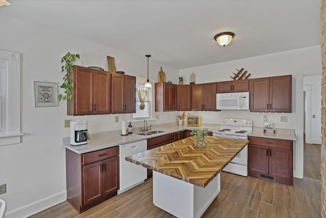 704 E High St, Mount Vernon, OH 43050 - kitchen with light wood-type flooring, a sink, white appliances, and light countertops