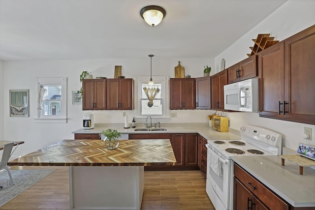 704 E High St, Mount Vernon, OH 43050 - kitchen featuring a wealth of natural light, white appliances, a sink, and butcher block counters