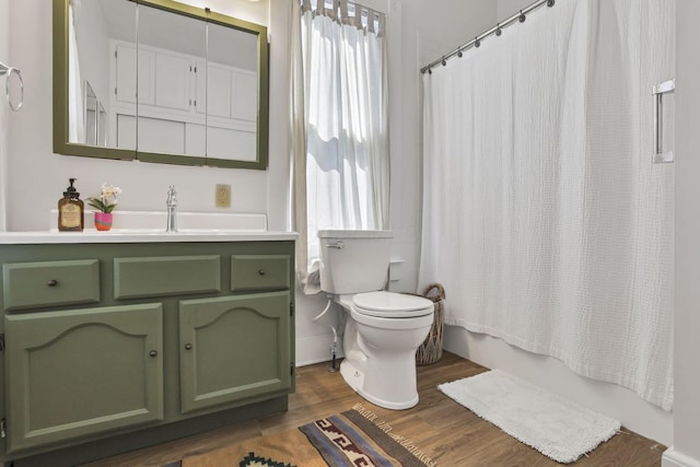 704 E High St, Mount Vernon, OH 43050 - full bath featuring shower / bath combination with curtain, wood finished floors, vanity, and toilet