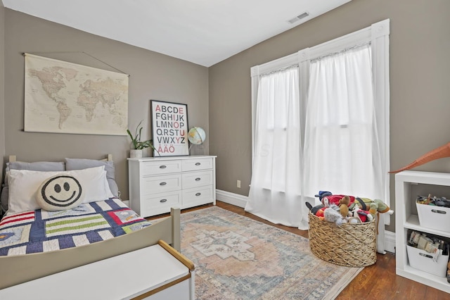 704 E High St, Mount Vernon, OH 43050 - bedroom featuring baseboards, visible vents, and dark wood-type flooring