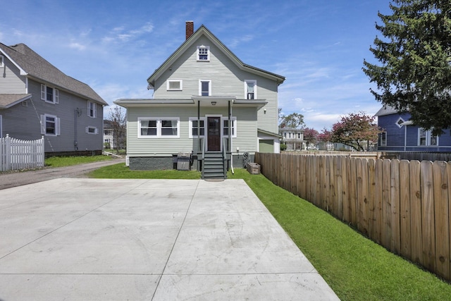 704 E High St, Mount Vernon, OH 43050 - view of front of home with fence, a chimney, and a front yard