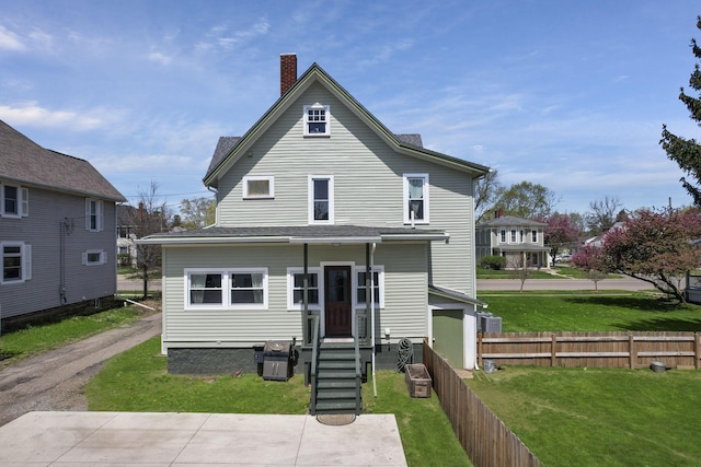 704 E High St, Mount Vernon, OH 43050 - view of front facade with a chimney, fence, and a front yard