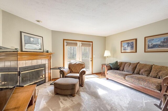 living room with a tile fireplace