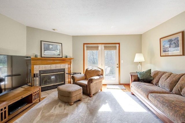 living area featuring wood finished floors and a tile fireplace