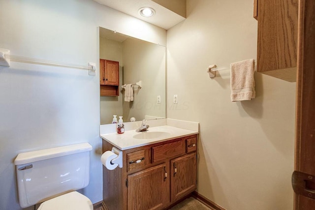 half bathroom featuring toilet and vanity