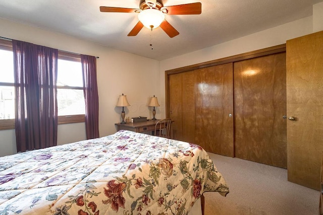 carpeted bedroom with a closet and a ceiling fan