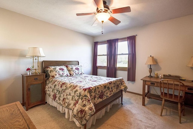 bedroom featuring ceiling fan, baseboards, and light carpet