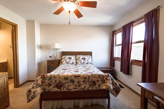 bedroom featuring ceiling fan, baseboards, and light colored carpet