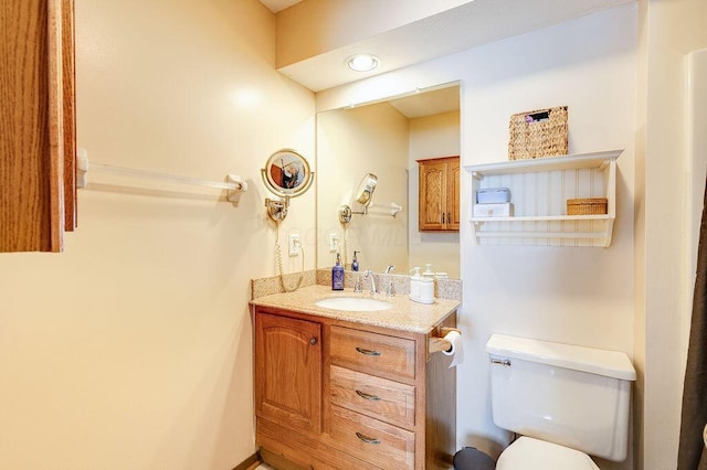 half bathroom featuring toilet and vanity
