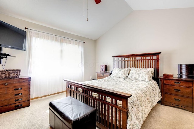 carpeted bedroom featuring lofted ceiling and a ceiling fan