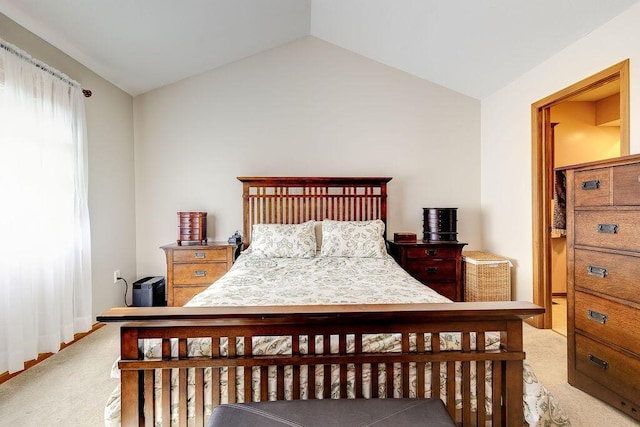 carpeted bedroom featuring lofted ceiling and baseboards