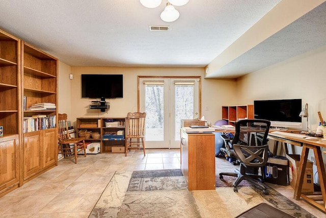 office area featuring light tile patterned flooring, a textured ceiling, visible vents, and french doors