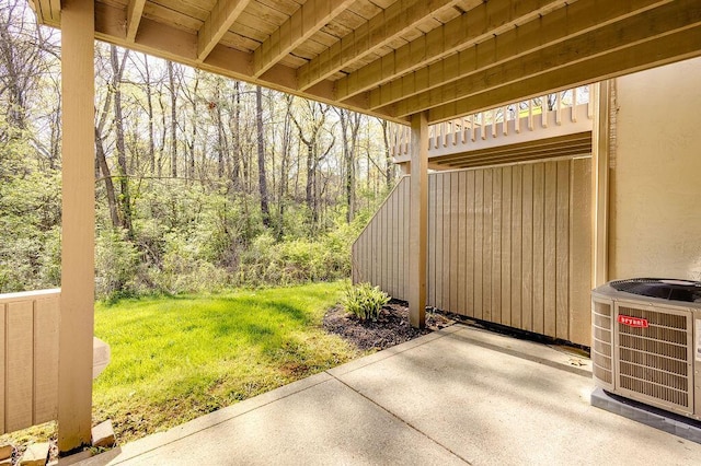 view of patio featuring a view of trees and central AC unit