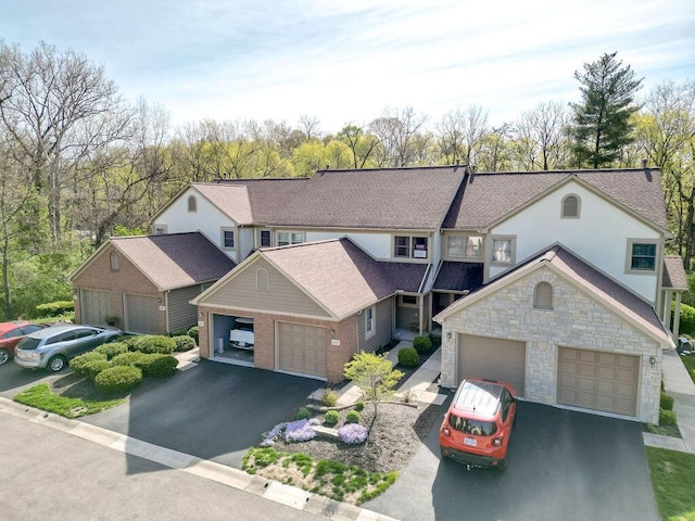 view of front of home with stone siding and aphalt driveway