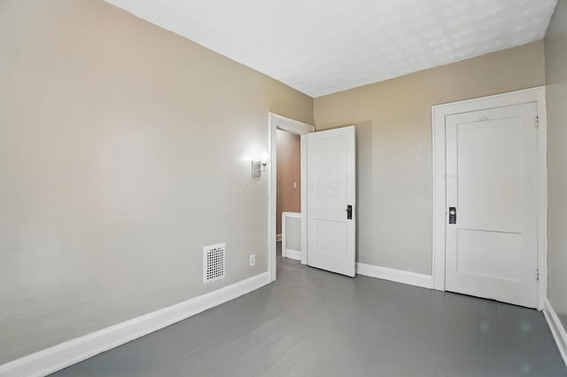 unfurnished bedroom with baseboards and visible vents