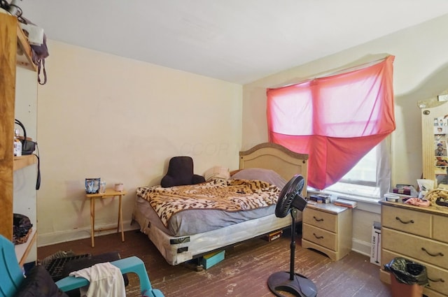 bedroom featuring baseboards and hardwood / wood-style flooring