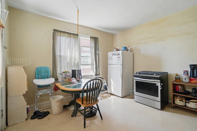kitchen featuring gas stove and freestanding refrigerator
