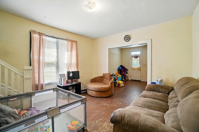 living area with stairway and wood finished floors