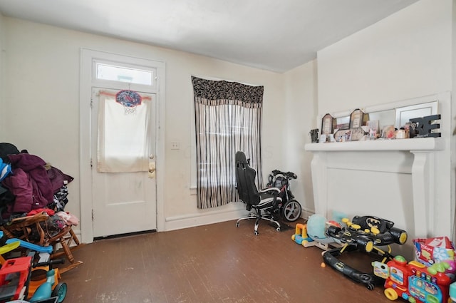 game room with baseboards and wood finished floors