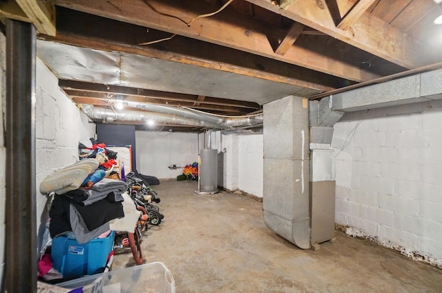 unfinished below grade area with water heater and heating unit