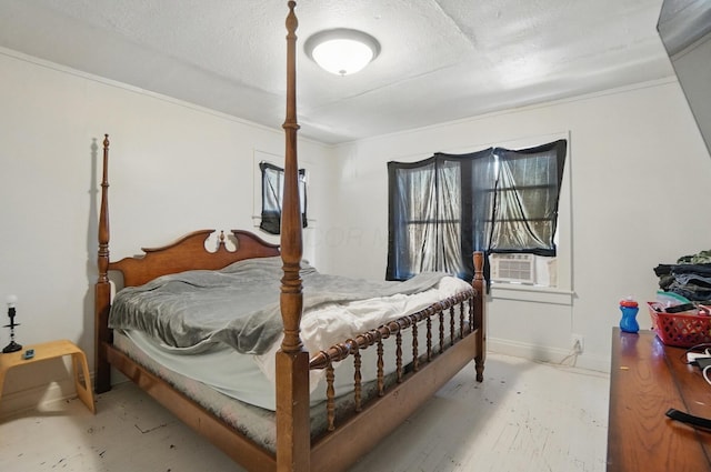 bedroom featuring a textured ceiling and cooling unit