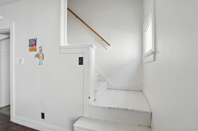 staircase featuring baseboards