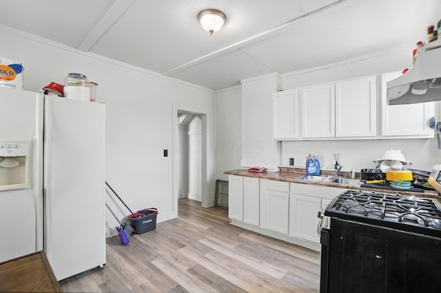 kitchen featuring range with gas stovetop, white refrigerator with ice dispenser, white cabinetry, a sink, and light wood-style flooring
