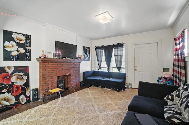 living room featuring a healthy amount of sunlight, crown molding, and a brick fireplace