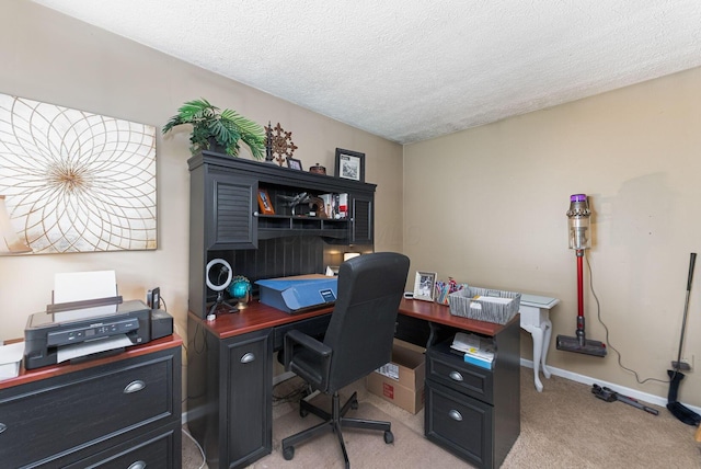 home office featuring light colored carpet, baseboards, and a textured ceiling