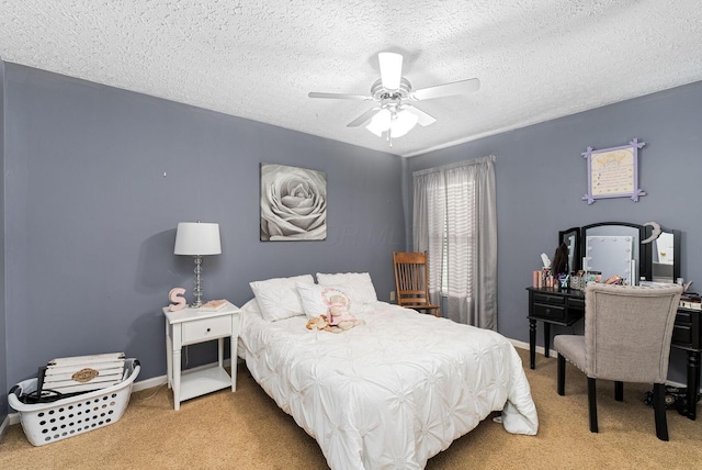 bedroom with ceiling fan, a textured ceiling, baseboards, and light carpet