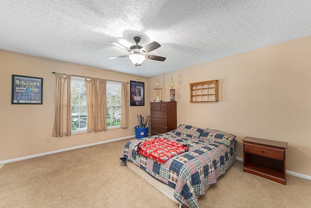 carpeted bedroom featuring baseboards, a ceiling fan, and a textured ceiling