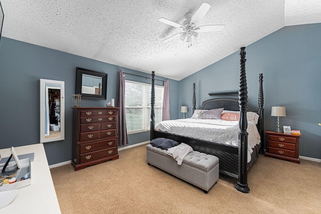 carpeted bedroom with lofted ceiling, baseboards, a textured ceiling, and ceiling fan