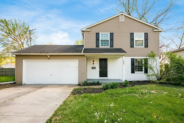 traditional-style home featuring a front yard, driveway, a garage, and covered porch